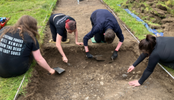 Four people excavating a trench