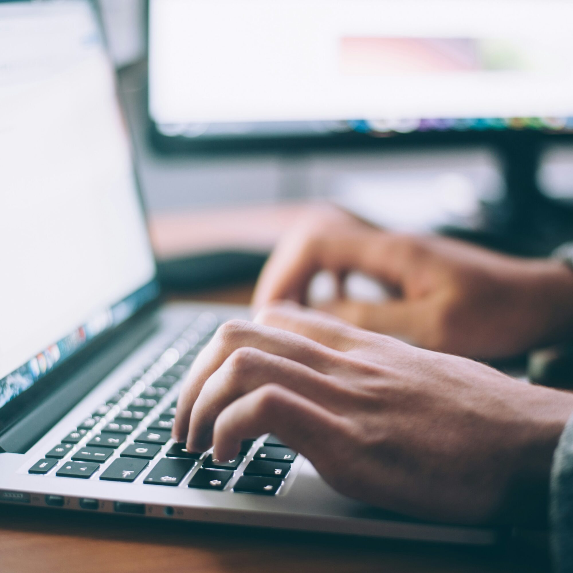 Person writing on a laptop