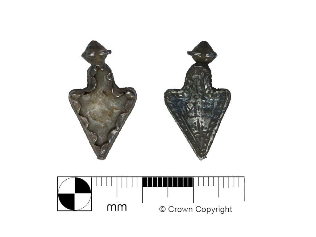 An amulet from the early modern period made of a prehistoric flint arrowhead in a silver setting
