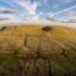 Aerial view of a rural landscape with a hill