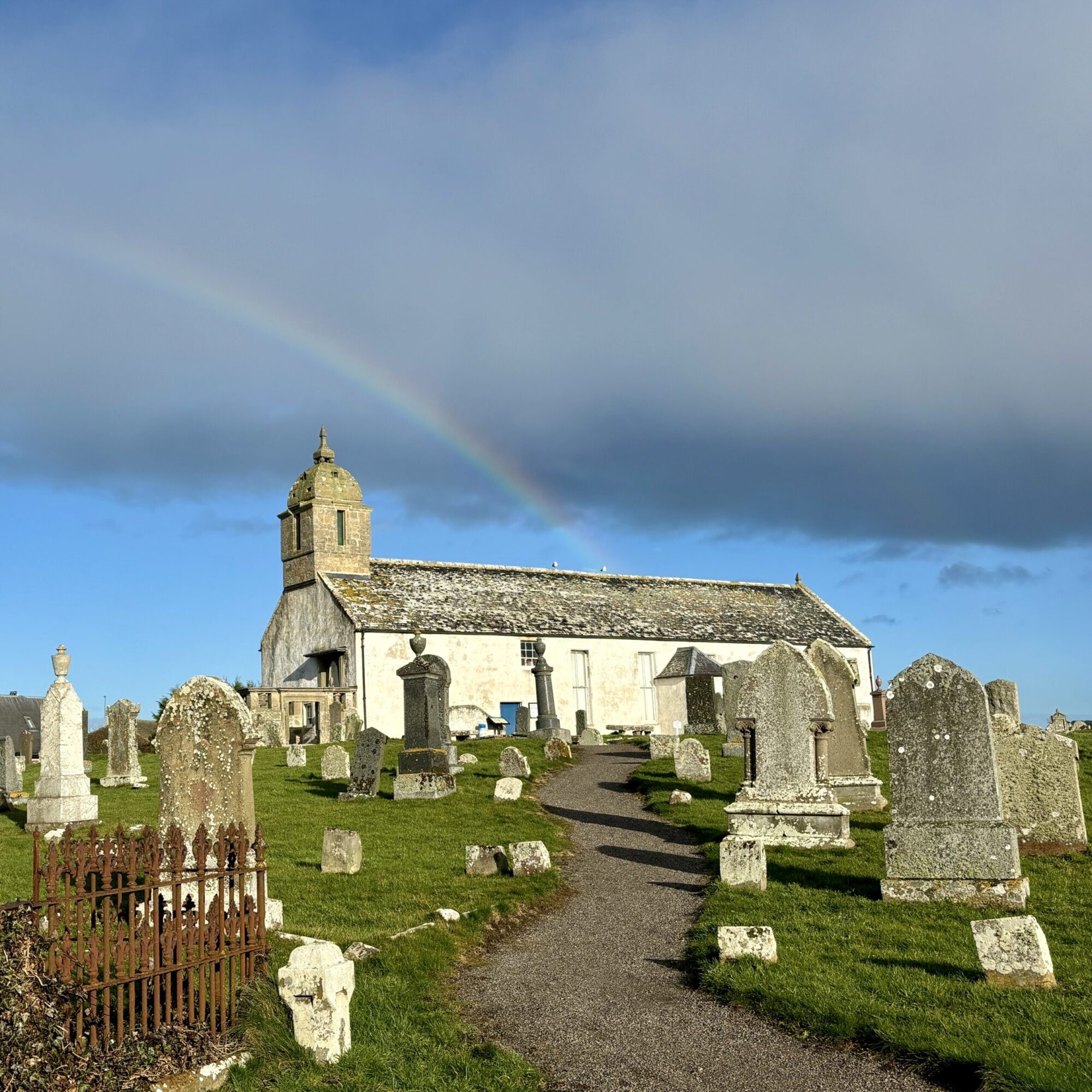 An old church with gravestones in the foreground