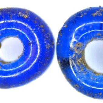Photo of two tiny blue glass beads