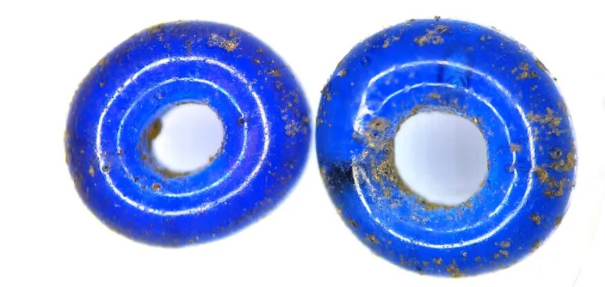 Photo of two tiny blue glass beads