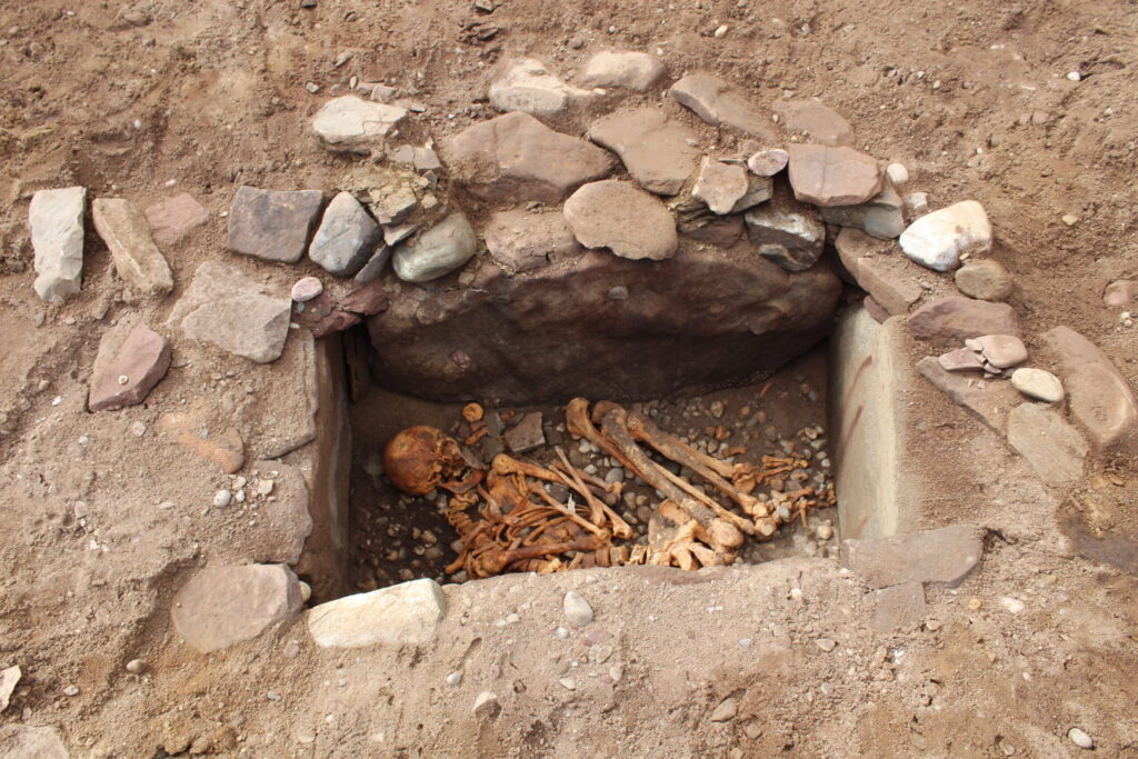 Photo of an excavated stone-lined prehistoric burial
