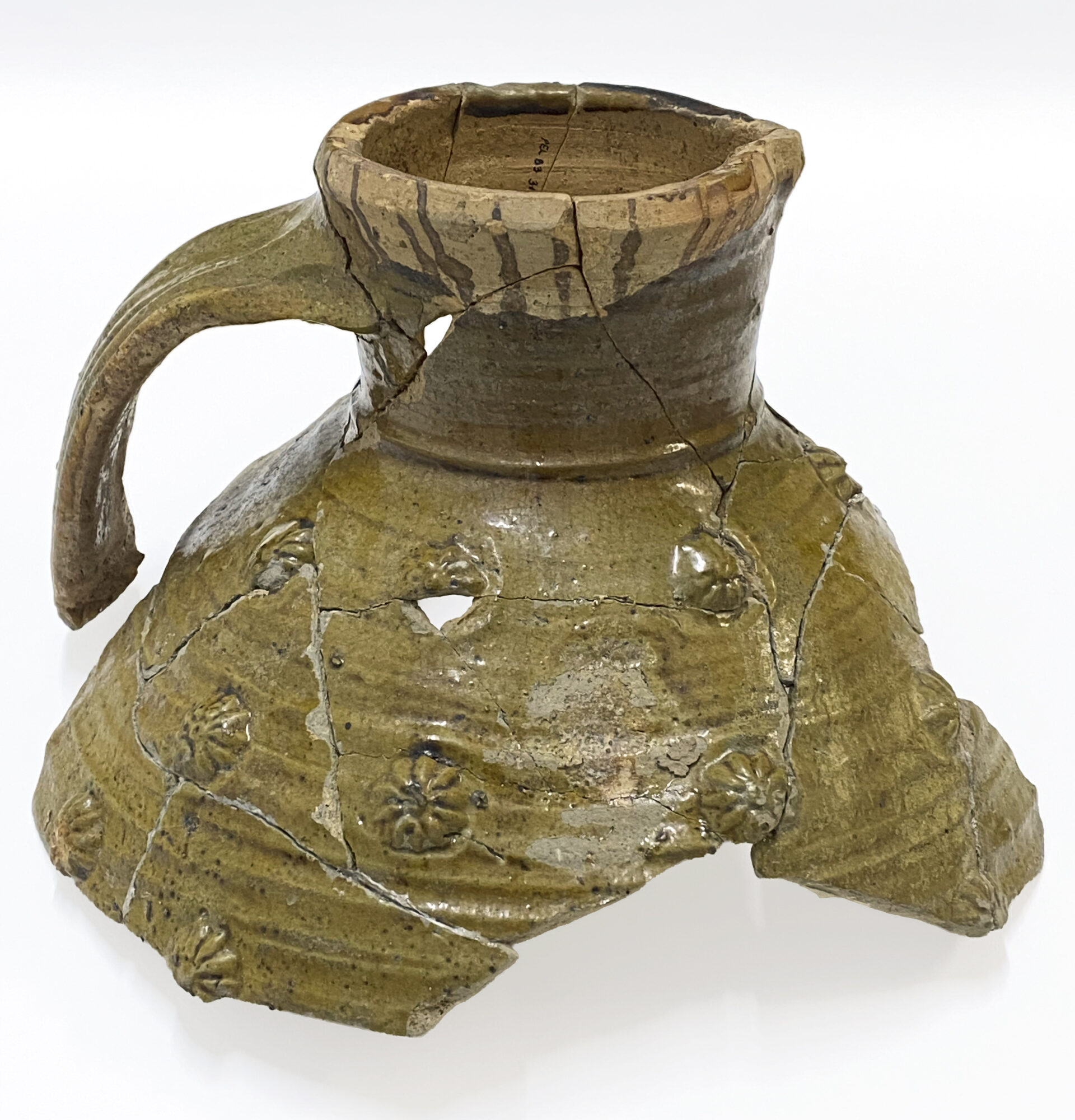 Photo of the trop half of a large medieval jug