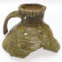 Photo of the trop half of a large medieval jug