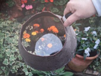 Photo of a brown metal jug with a glass bottom