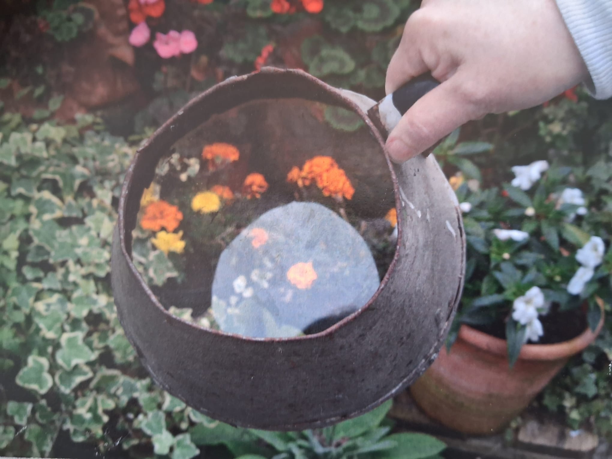 Photo of a brown metal jug with a glass bottom