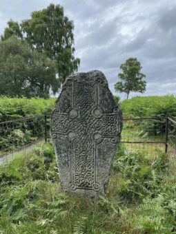 The Kinord Cross is a Class III Pictish cross slab located in the Muir of Dinnet National Nature Reserve. Dating from the later Pictish period, the stone features an ornate, interlace-filled cross that dominates its surface. The cross has three equal-length, square-ended arms, with spirals at each corner and circular hollows in the angles between the arms, all linked by a ring. Uniquely, the spirals at the base of the shaft are double, while the others are single.