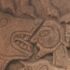 Photo of a carved stone showing a lion's head and a man