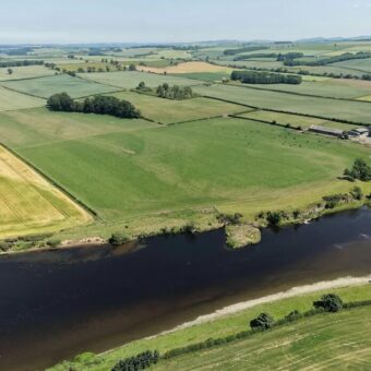 Aerial photo of a river with fields on either side