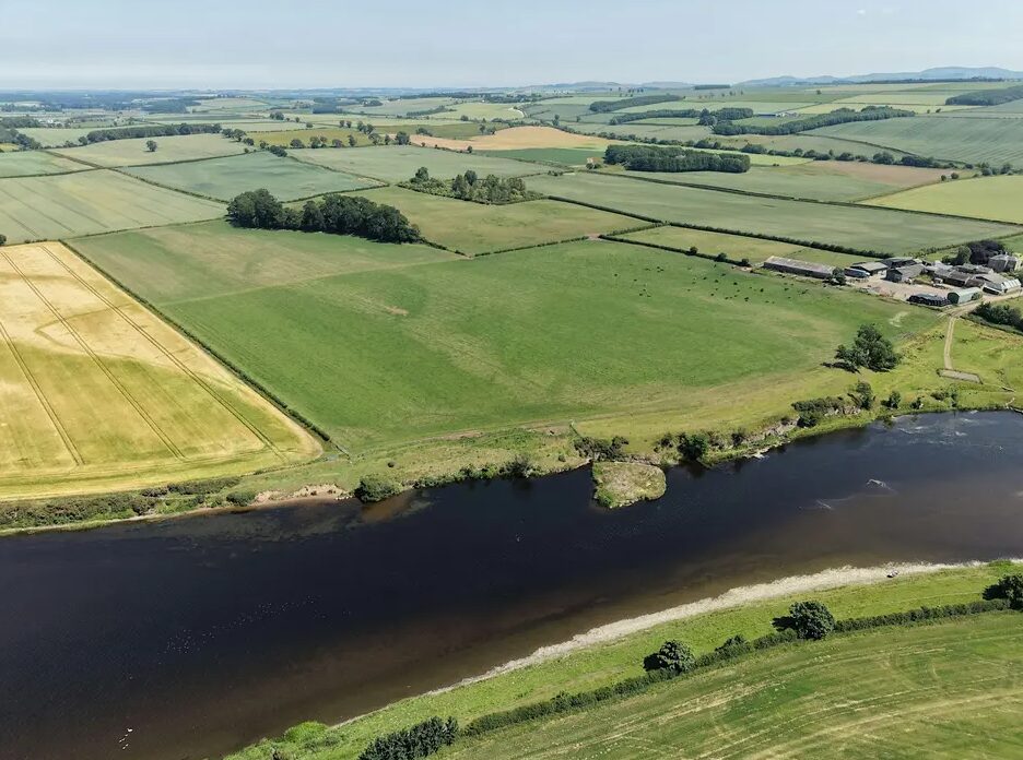 Aerial photo of a river with fields on either side