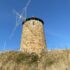 Photo of a stone windmill on a beach