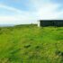 Historic structures in a grassy landscape