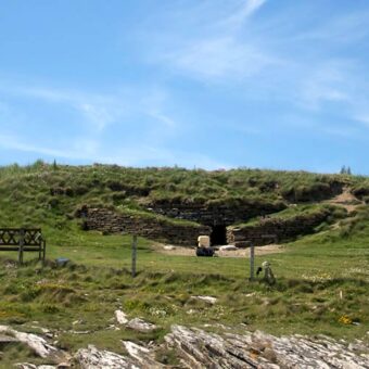 Prehistoric tomb surrounded by grass