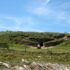 Prehistoric tomb surrounded by grass