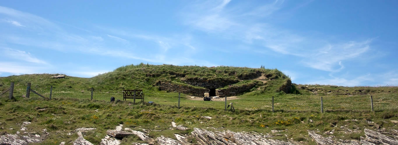 Prehistoric tomb surrounded by grass