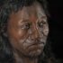 Photo of a facial reconstruction of a dark-skinned man with long black hair